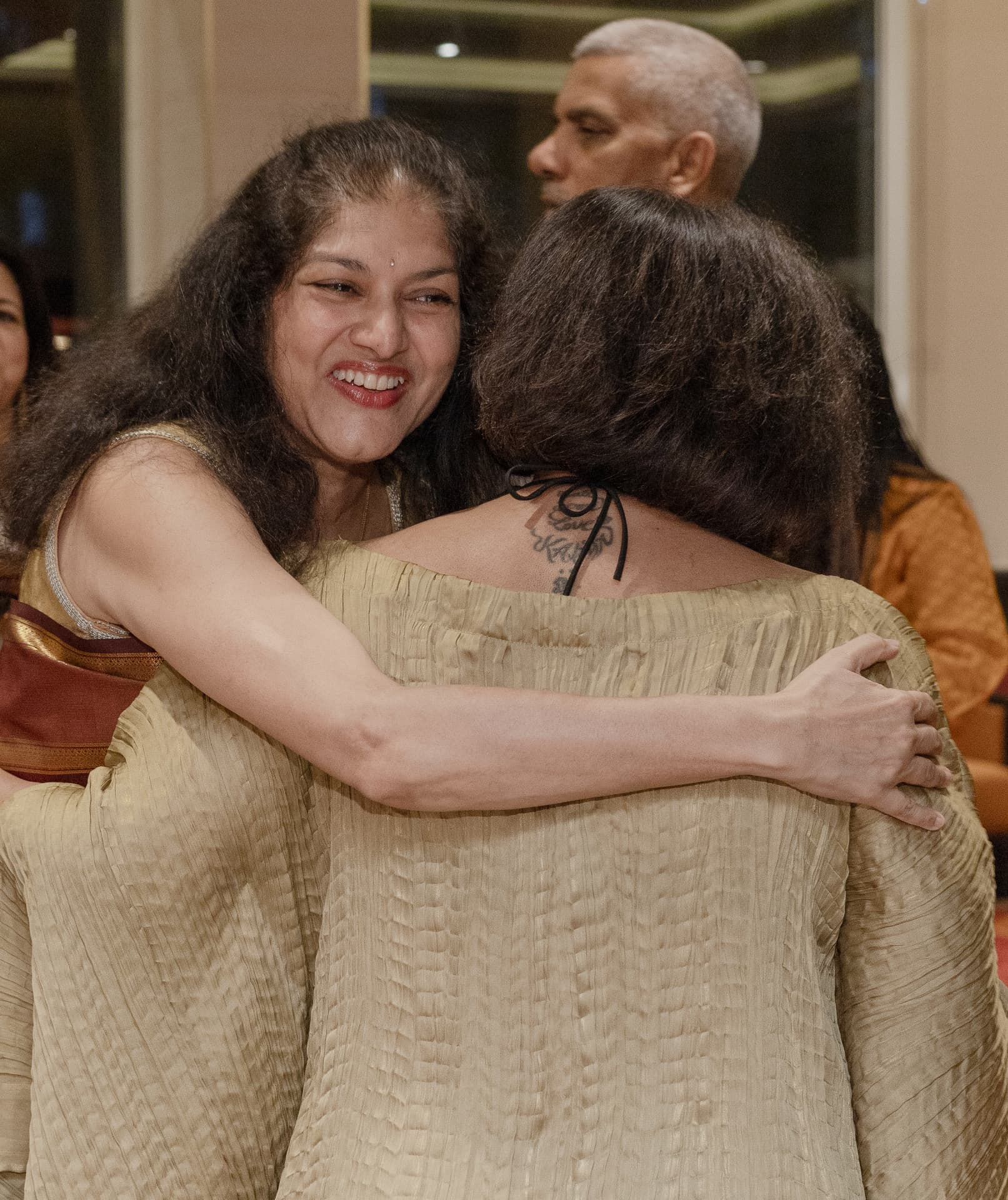 A warm embrace between guests after the concert