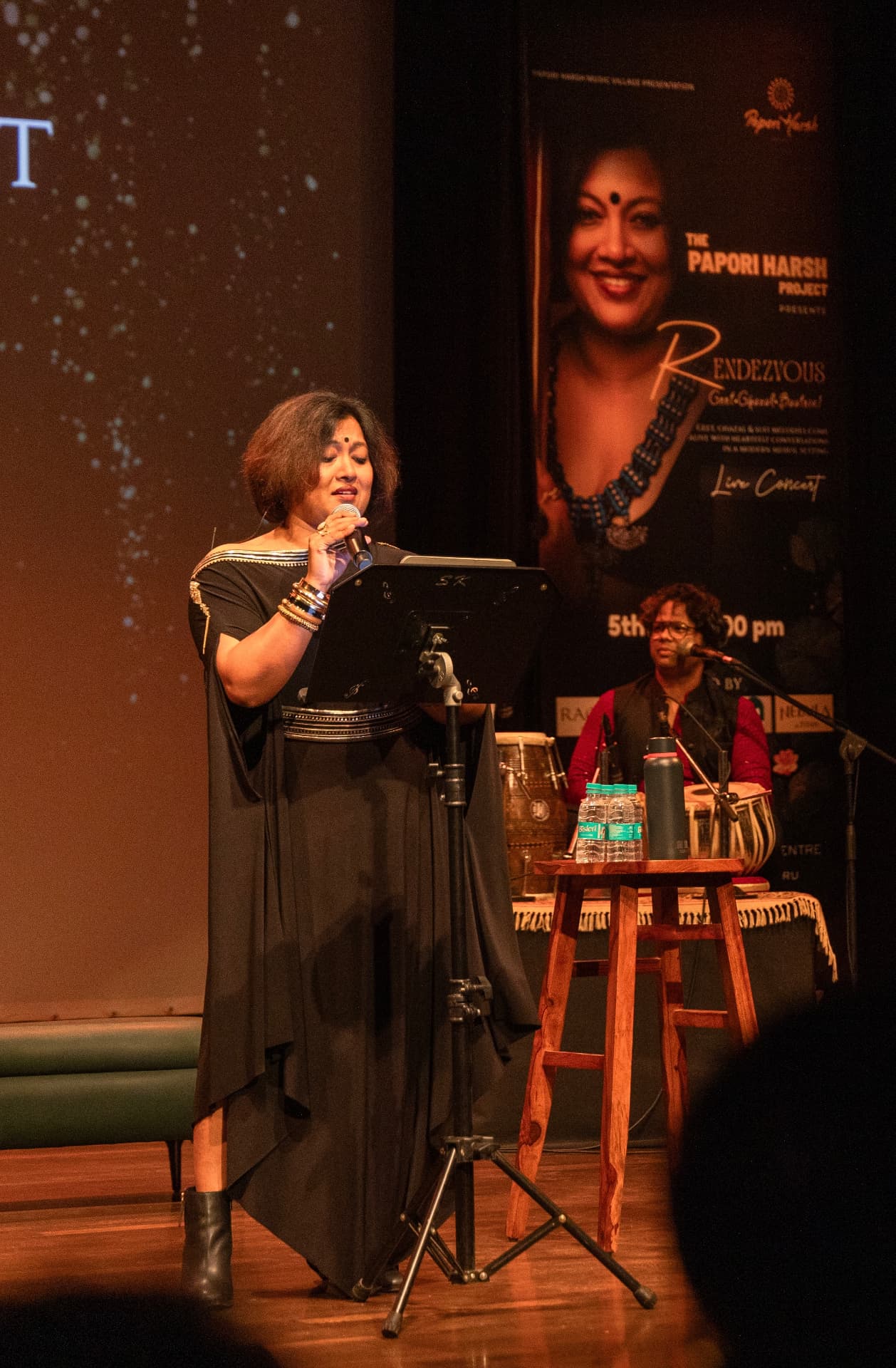 Paapori Harsh singing at the music stand during Rendezvous