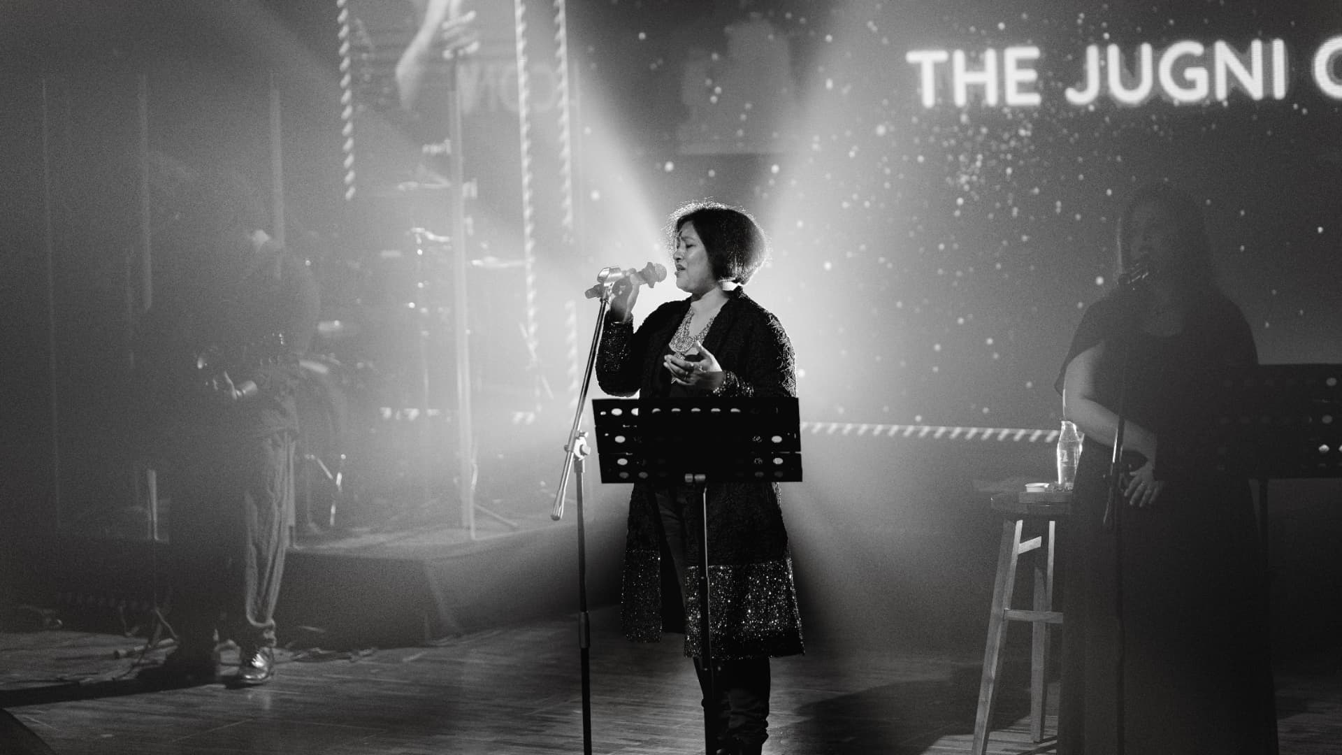 Black and white frame of Paapori Harsh singing at The Jugni Concert