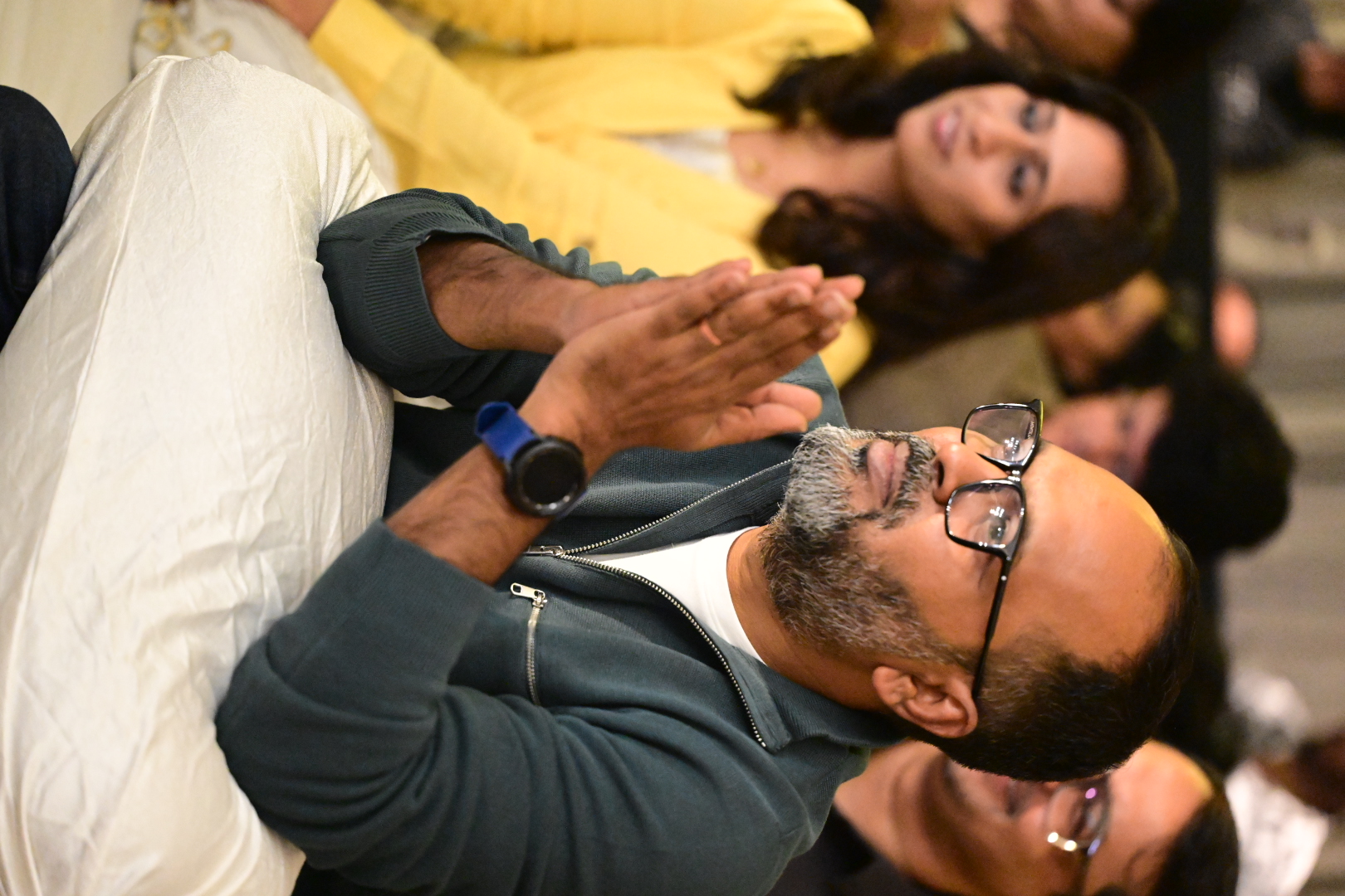 An audience member with folded hands during the concert
